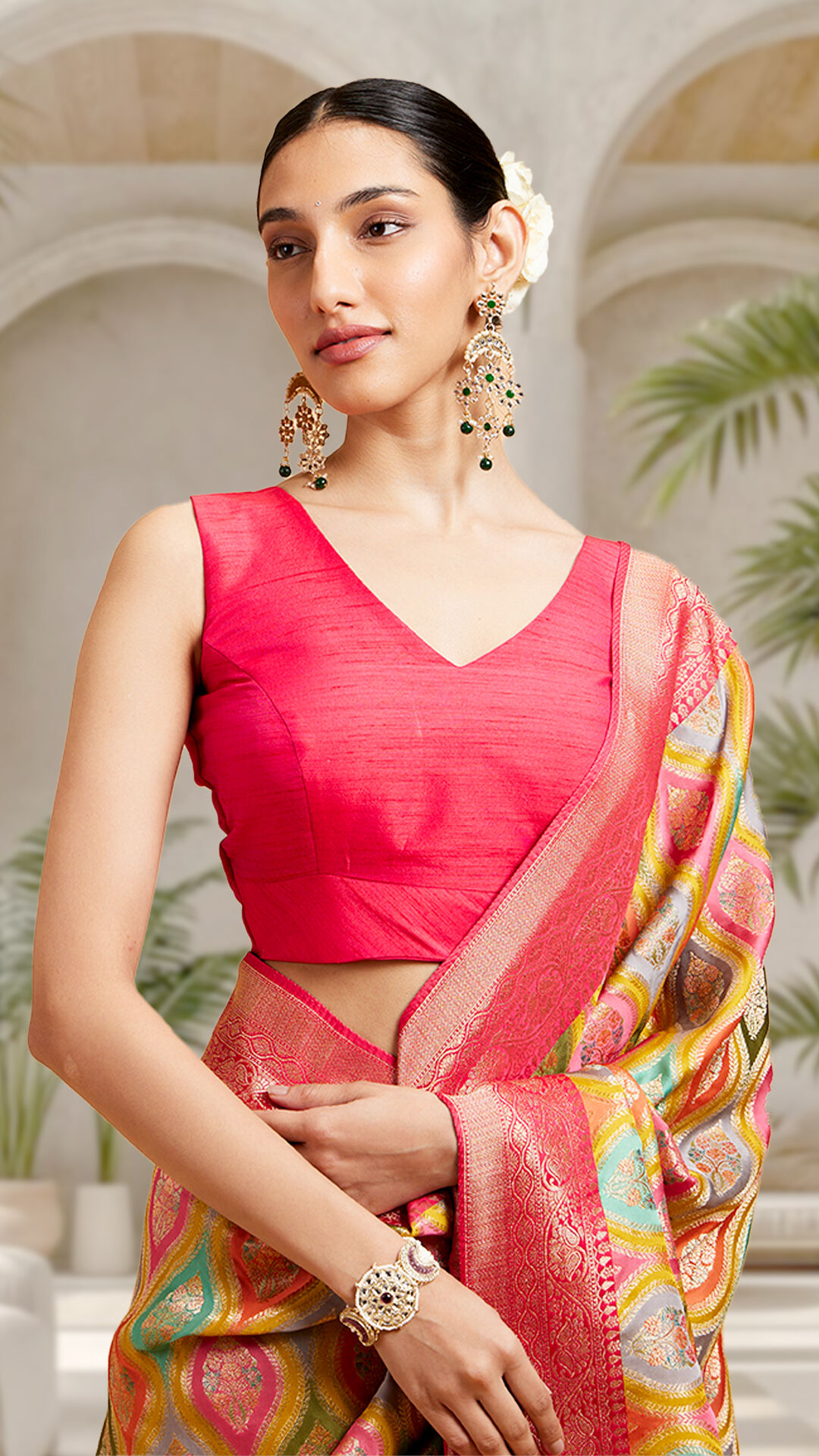 A woman posing in a colourful saree look