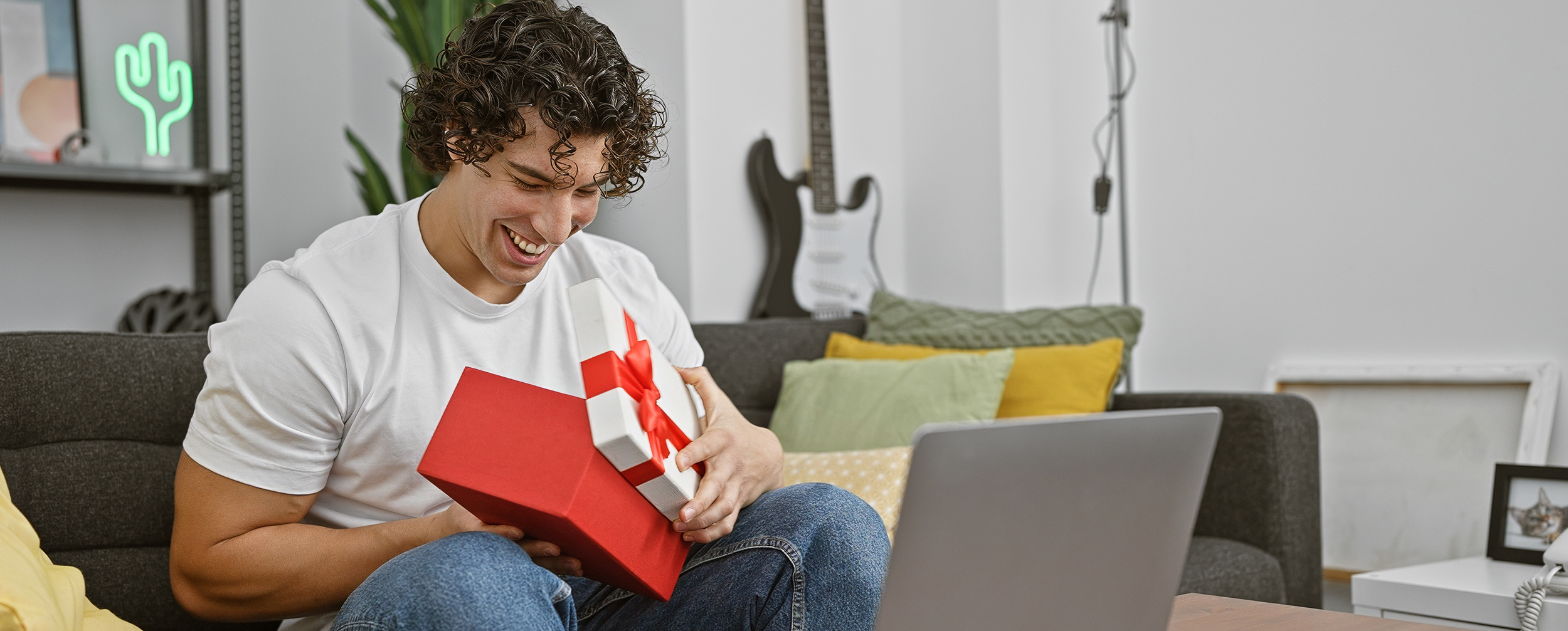 Man receiving beautifully wrapped wedding gifts with joy.