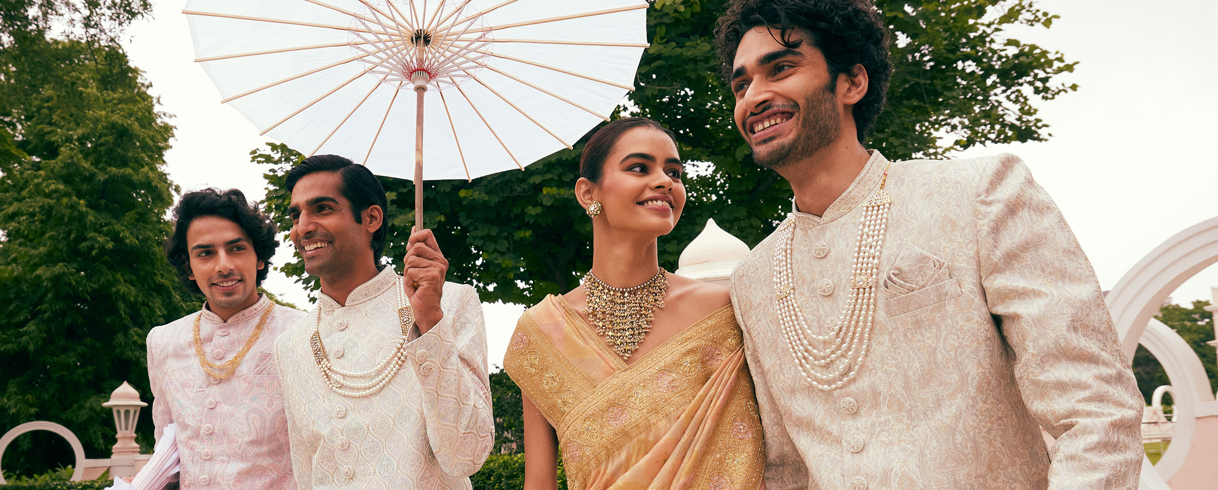 A groom wearing a sherwani with a mala