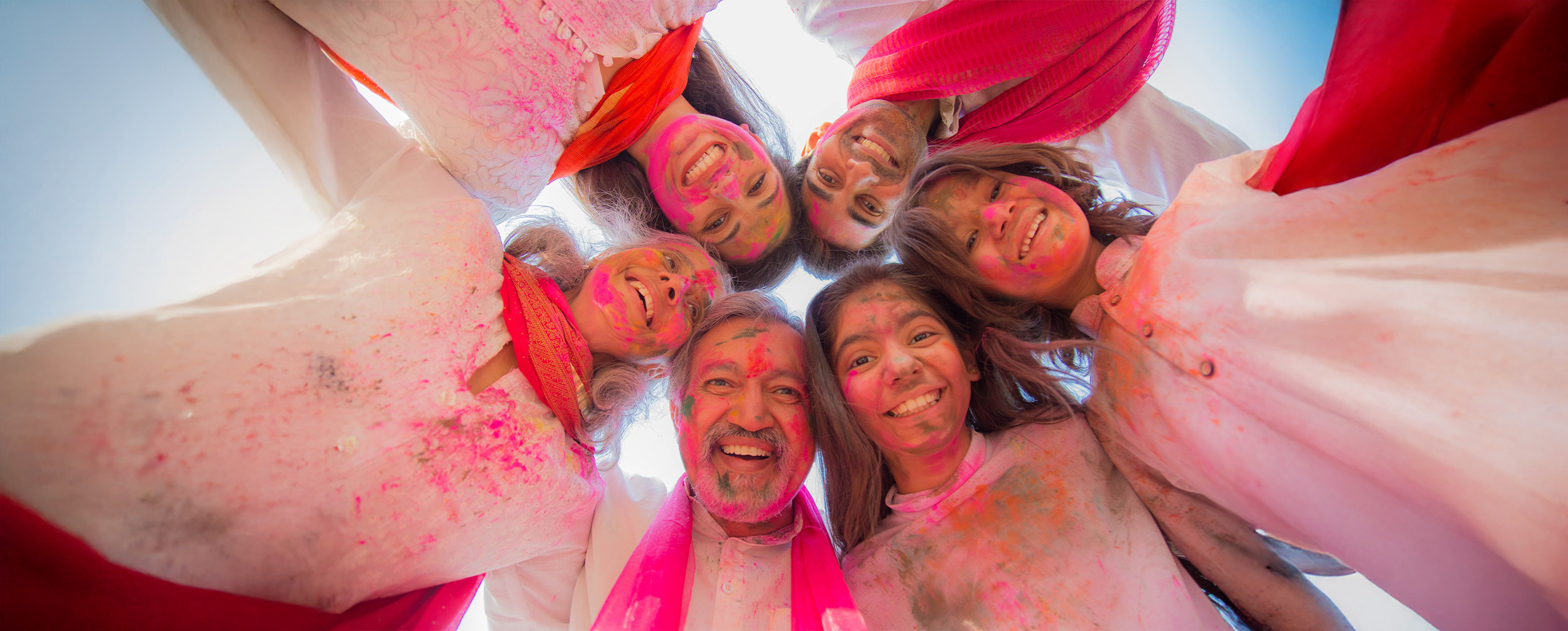 beautifull family enjoying holi celebration with colours at home